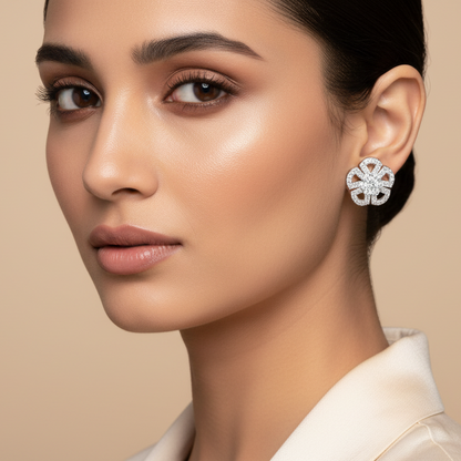 Woman wearing a pair of earrings against a beige background