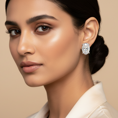 Woman wearing a diamond earring against a beige background