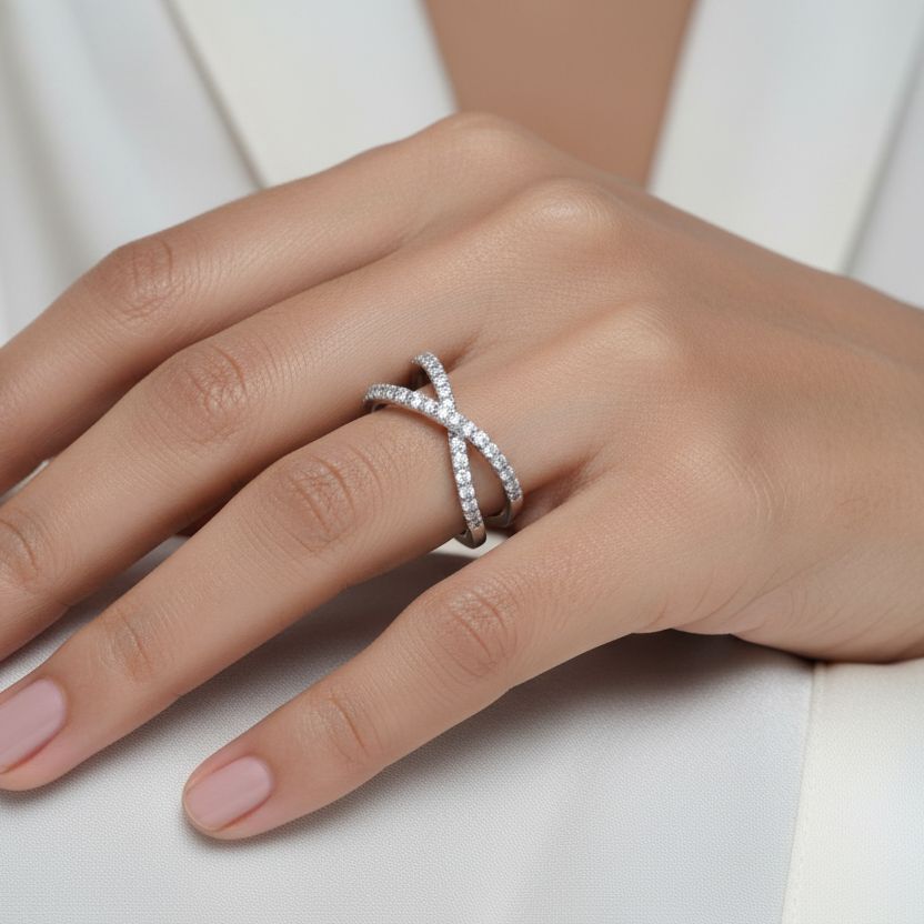 Hand wearing a silver ring on a white background