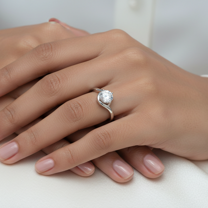 Generated image of a beautiful Indian female model wearing the white gold round brilliant diamond bypass solitaire engagement ring with large round brilliant diamond blazing with extraordinary icy fire in four-claw setting cradled within a beautiful sculptural sweeping bypass shank with two smooth wide white gold arms curving gracefully around and beneath the diamond setting in a beautiful dynamic flowing silhouette