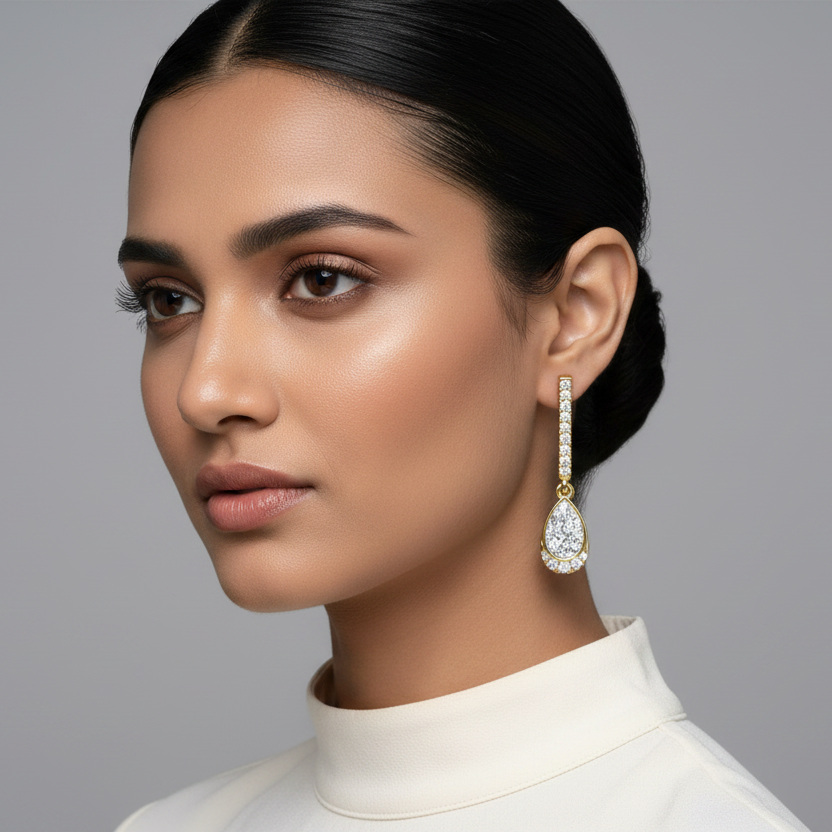 Generated image of a beautiful Indian female model wearing the yellow gold straight pavé diamond bar drop earrings with spectacular pear-shaped illusion cluster diamond pendants featuring smooth yellow gold bezel frames filled with illusion-set multi-stone diamond clusters and delicate partial pavé halo accents at the rounded base