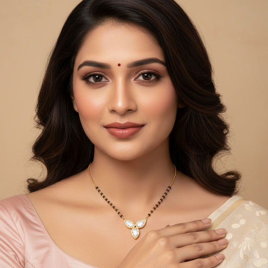Generated image of a beautiful Indian married female model wearing the yellow gold three pear-cut diamond trefoil mangalsutra with three large pear-cut diamonds in smooth full yellow gold bezel settings arranged in a beautiful trefoil fleur-de-lis cluster pendant on a traditional black bead and yellow gold chain, warm studio lighting on champagne background with soft ivory silk blouse and delicate bindi