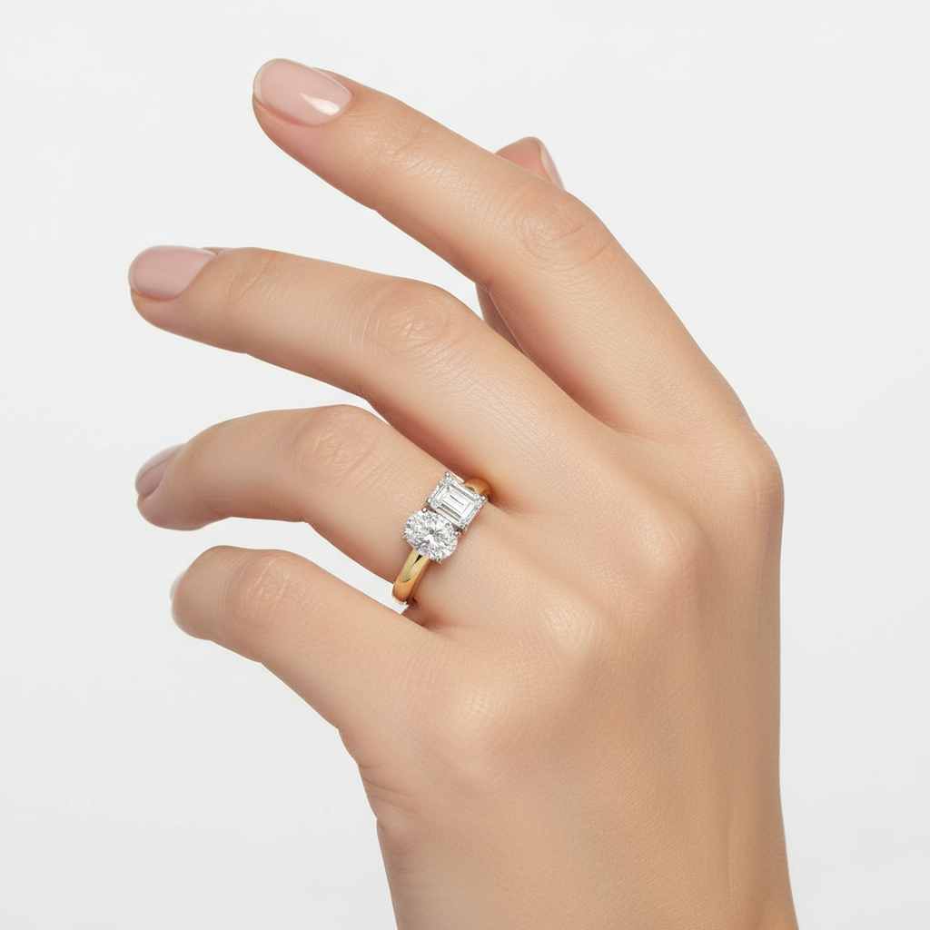 Hand wearing a diamond ring on a light gray background