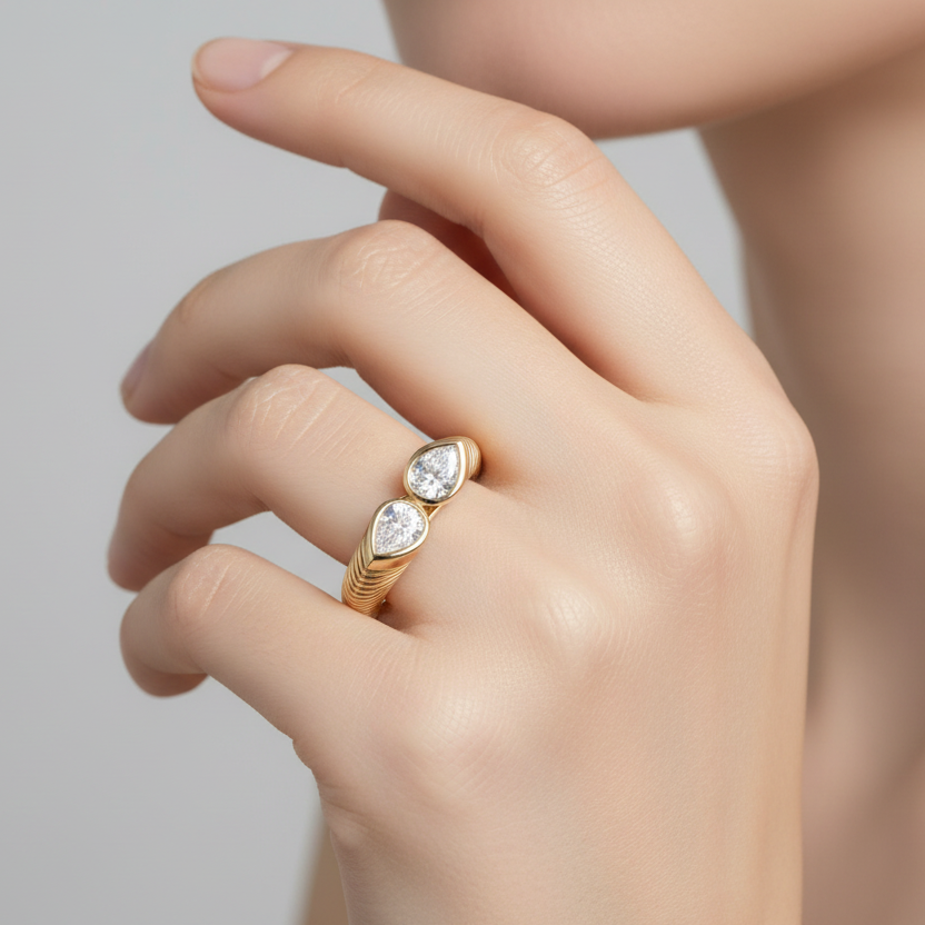 Generated image of a female model wearing the yellow gold bypass ring with pear-shaped diamonds