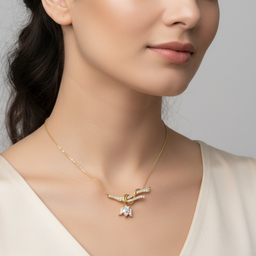 Generated image of a female model wearing the yellow gold love knot pendant with pear-shaped diamond drop