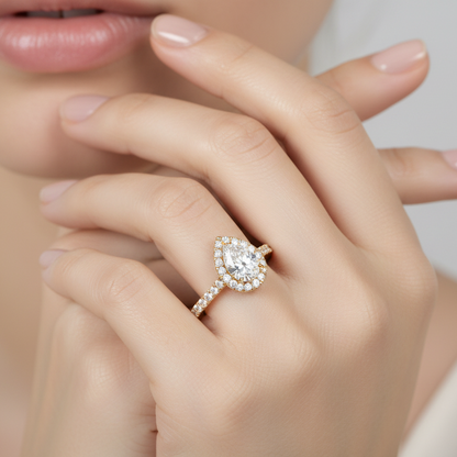 Generated image of a female model wearing the yellow gold pear-shaped halo engagement ring with pavé diamond band
