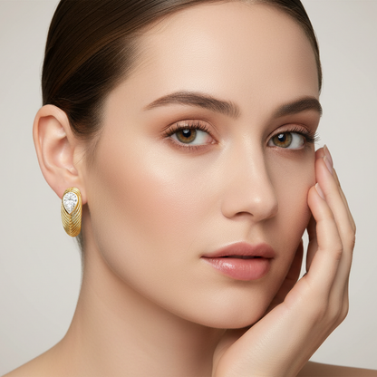 Generated image of a female model wearing the yellow gold textured hoop earrings with pear-shaped diamonds
