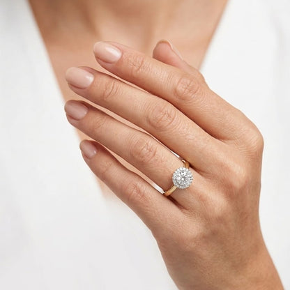Hand wearing a diamond ring on a white background