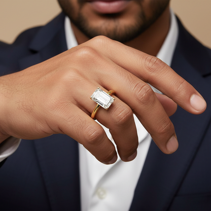 Man wearing a gold ring with a diamond on his finger, dressed in formal attire.