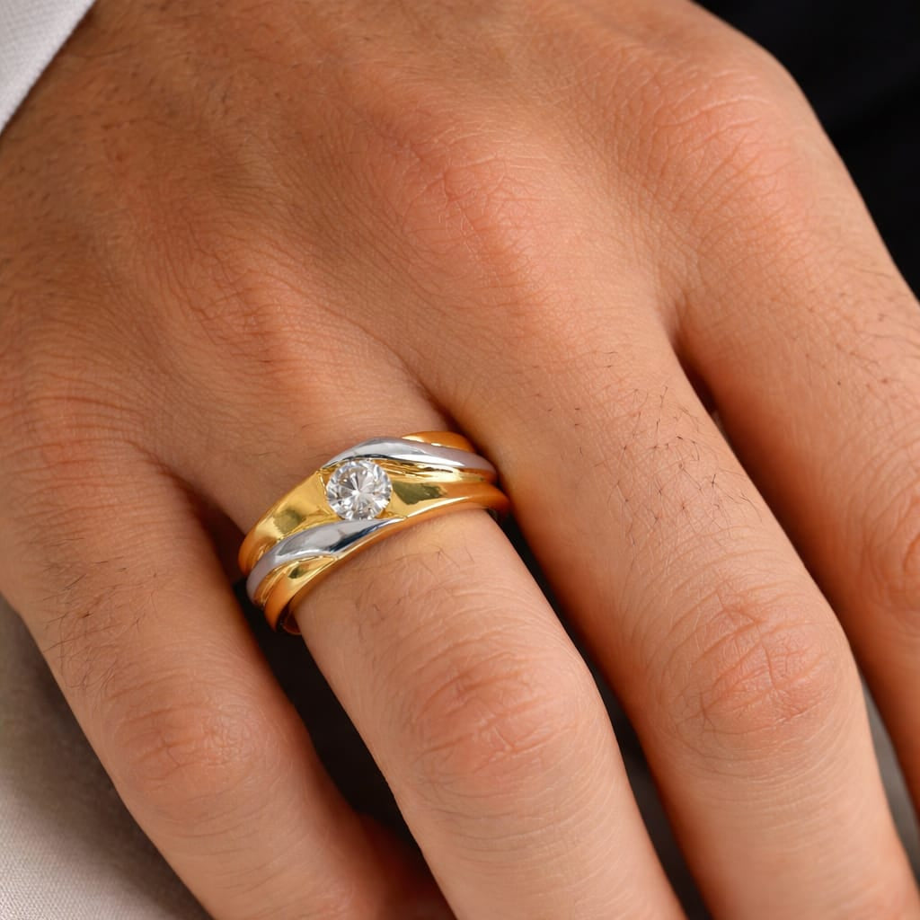 Gold ring with a diamond on a person's finger against a neutral background