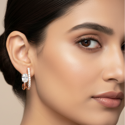 Generated image of an Indian female model wearing the rose gold double-bar J-hoop earrings with oval diamond solitaire and pavé diamonds