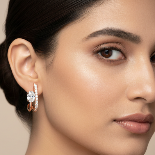 Generated image of an Indian female model wearing the rose gold double-bar J-hoop earrings with oval diamond solitaire and pavé diamonds