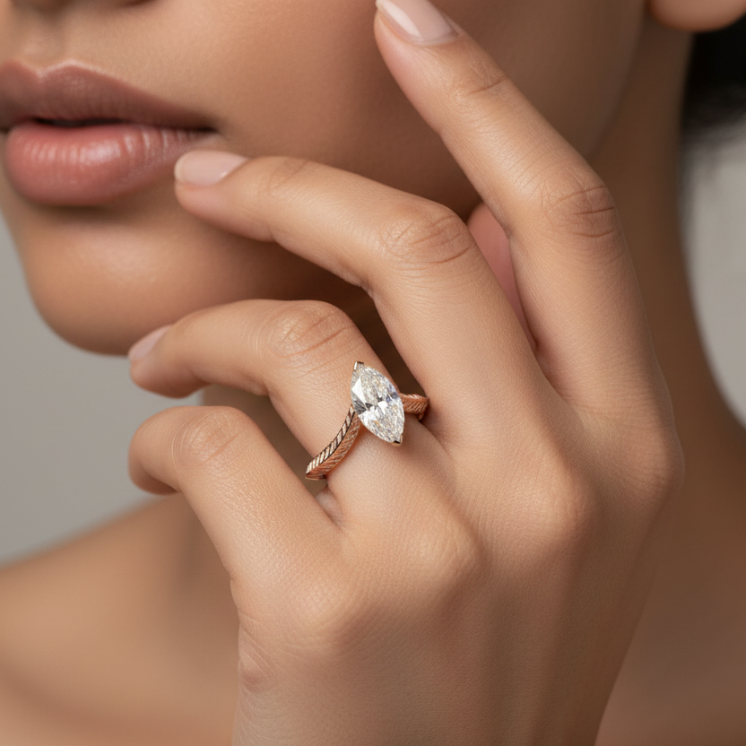 Generated image of an Indian female model wearing the rose gold two-prong marquise diamond solitaire engagement ring with dramatic V-shaped chevron split shank and intricate herringbone engraved band
