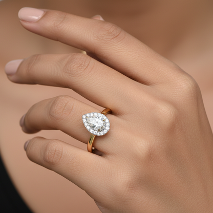 Generated image of an Indian female model wearing the two-tone yellow and white gold pear-cut halo engagement ring with plain polished band