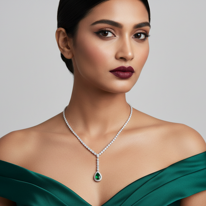 Generated image of an Indian female model wearing the white gold graduating diamond tennis Y-necklace with vivid green pear emerald diamond halo pendant drop