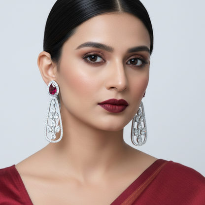 Generated image of an Indian female model wearing the white gold pear ruby halo stud top with open diamond botanical vine teardrop drop earrings in a very small petite size