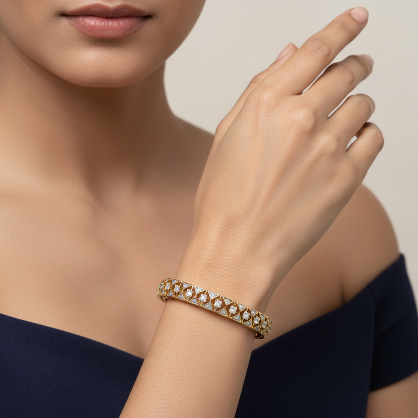 Generated image of an Indian female model wearing the yellow gold Art Deco geometric triangle lattice bangle with alternating pavé diamond triangles and round brilliant solitaire diamond stations