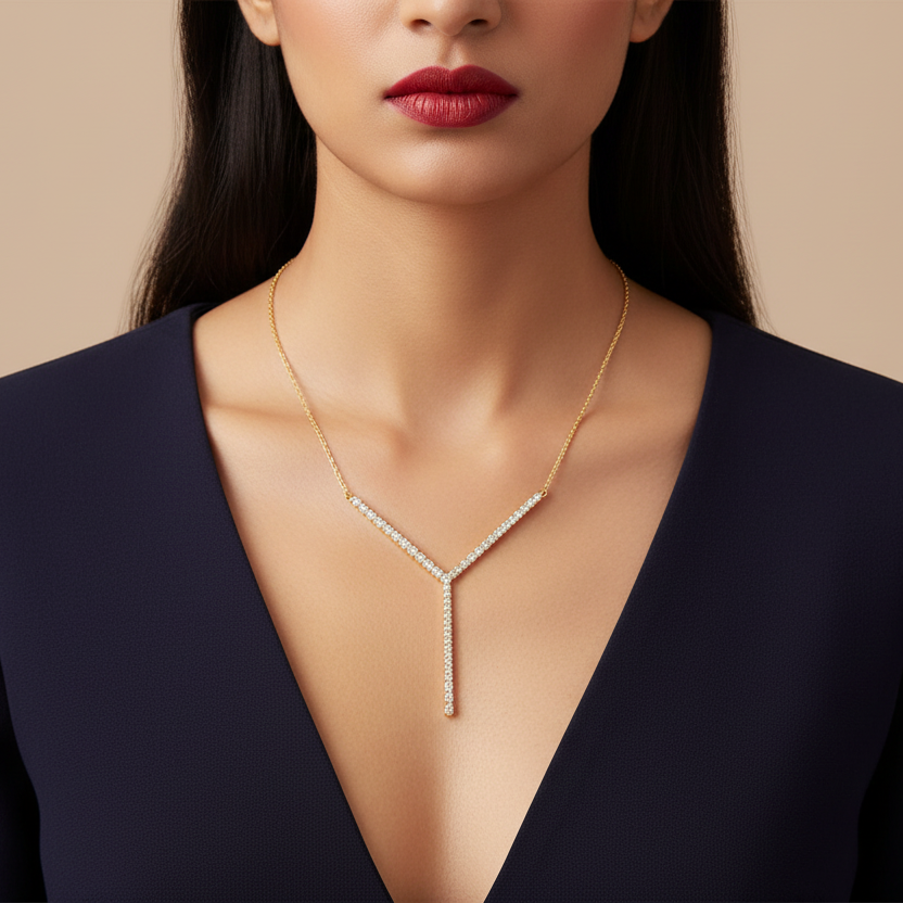 Generated image of an Indian female model wearing the yellow gold asymmetric diamond pavé Y-lariat necklace with long vertical drop bar