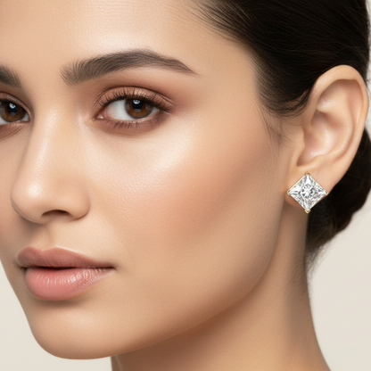 Generated image of an Indian female model wearing the yellow gold four-prong princess-cut diamond solitaire stud earrings