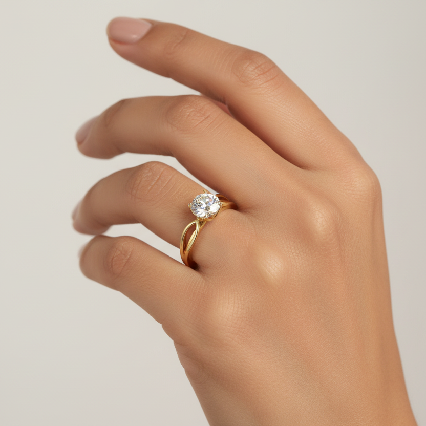 Generated image of an Indian female model wearing the yellow gold four-prong round brilliant solitaire engagement ring with infinity split shank band