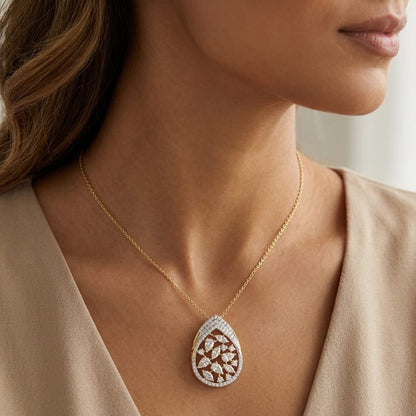 Gold necklace with a diamond pendant worn by a model against a neutral background
