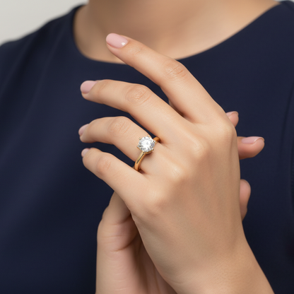 Generated image of an Indian female model wearing the yellow gold six-prong round brilliant diamond solitaire engagement ring in a very small petite size