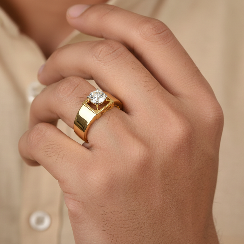 Generated image of an Indian male model wearing the yellow gold four-prong round brilliant solitaire ring with bold square gallery frame and ornate filigree under-gallery