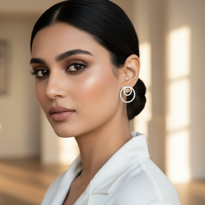 Woman wearing a white blazer in a softly lit room