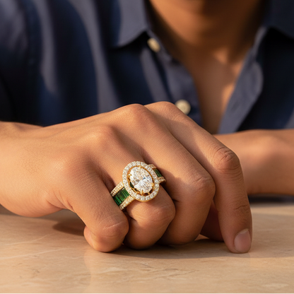 Generated warm lifestyle variation - handsome Indian male model wearing the yellow gold oval diamond double halo ring with vivid green emerald baguette full-eternity triple-row shank, warm golden hour light on champagne background with relaxed white linen shirt styling and hand resting on warm marble surface