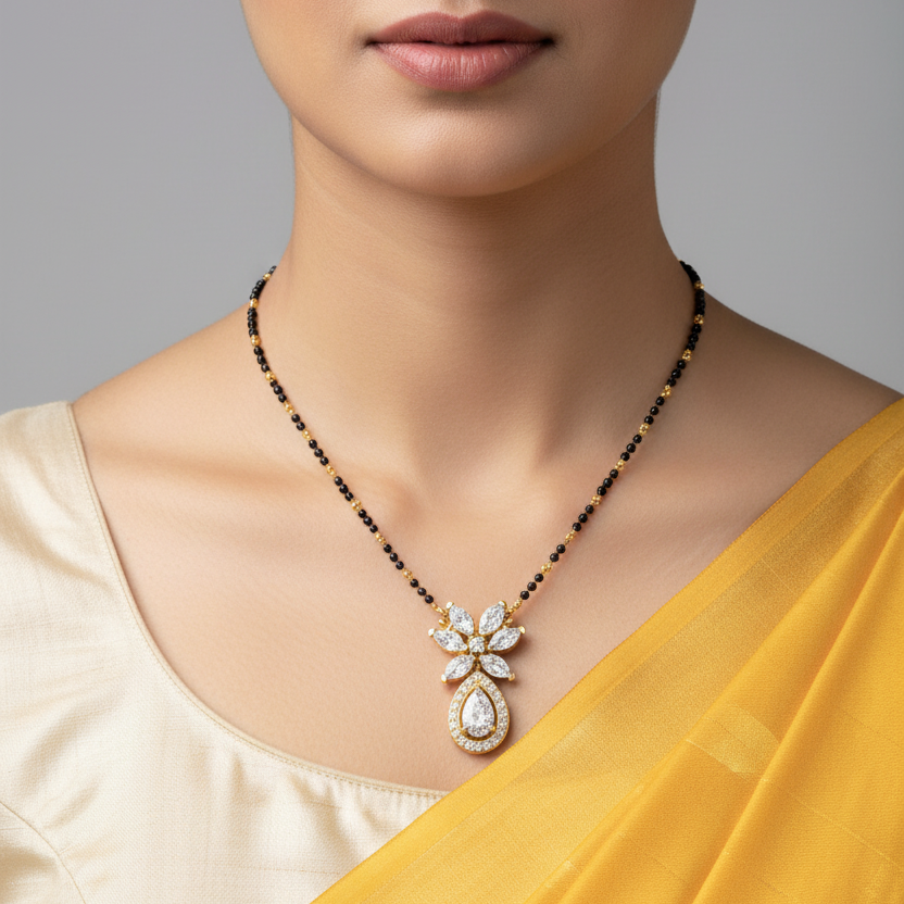 Indian female model wearing yellow gold marquise and pear diamond mangalsutra pendant on black bead chain