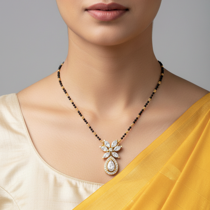 Indian female model wearing yellow gold marquise and pear diamond mangalsutra pendant on black bead chain