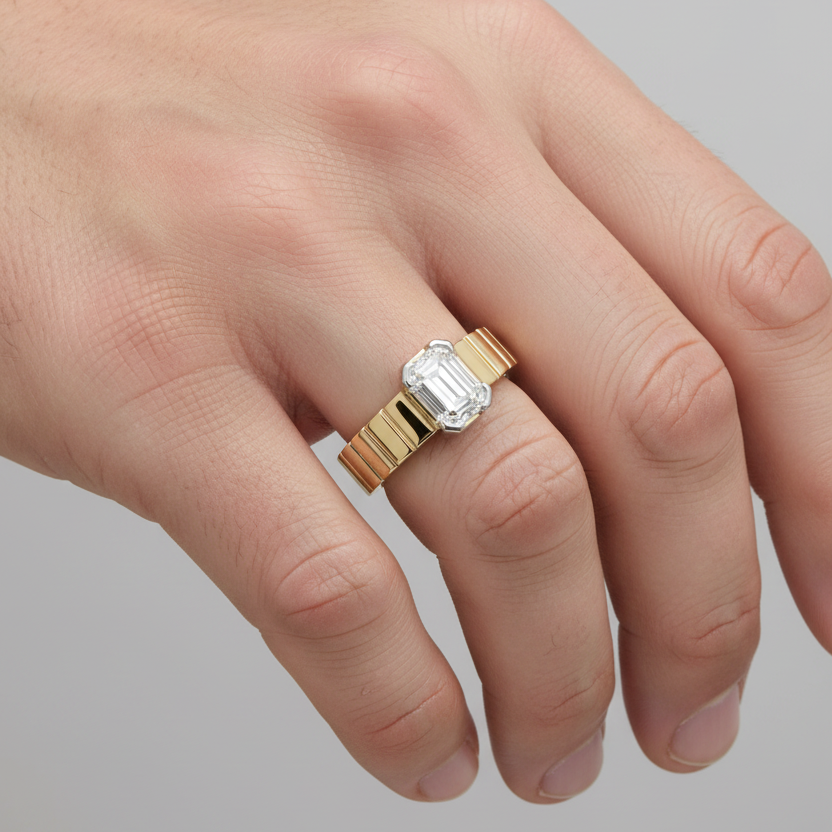 Male model wearing two-tone yellow gold ribbed band emerald-cut diamond solitaire ring
