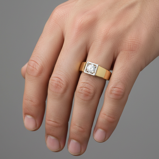 Male model wearing two-tone yellow gold signet-style round diamond solitaire ring with square white gold bezel