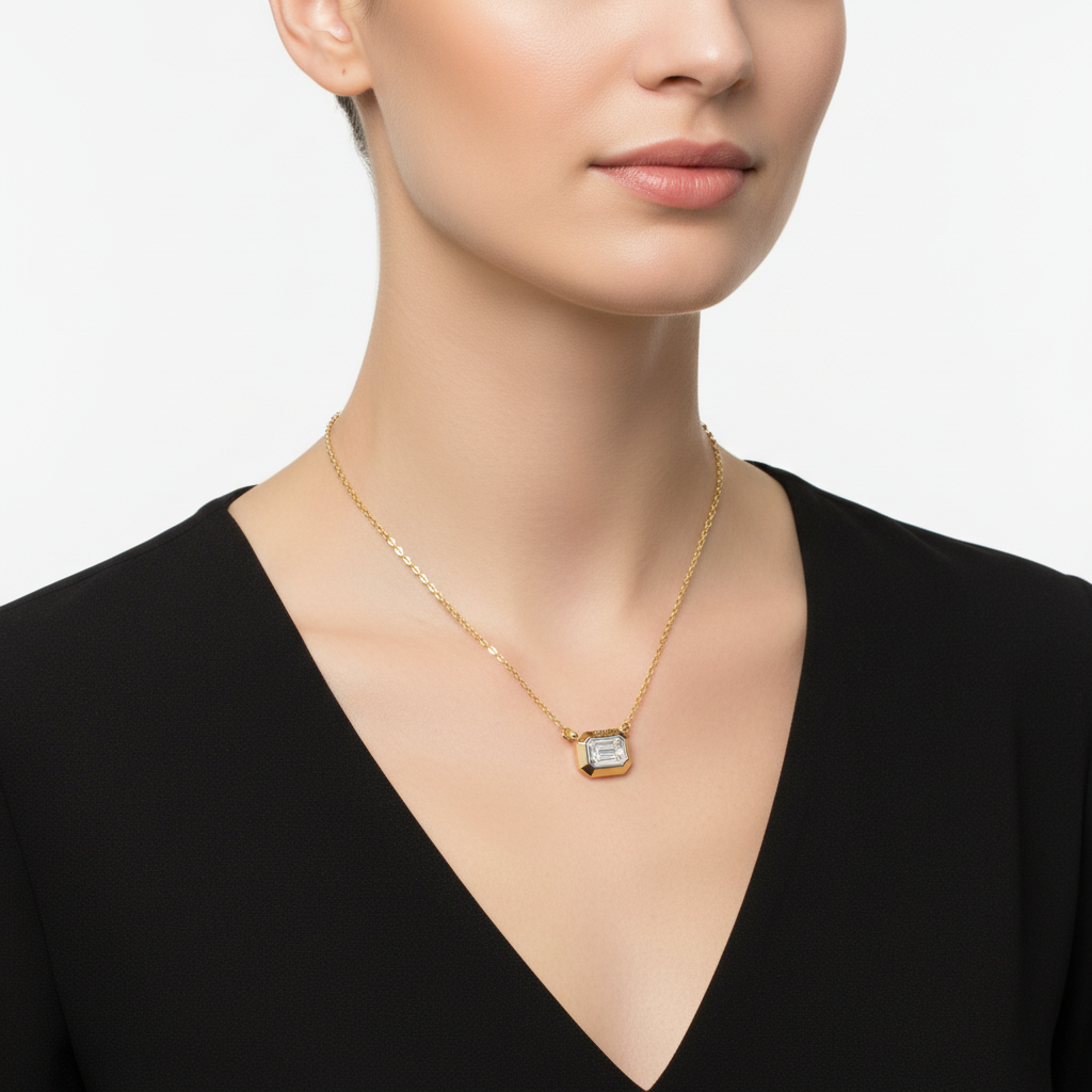 Two-tone emerald-cut diamond pendant necklace on model