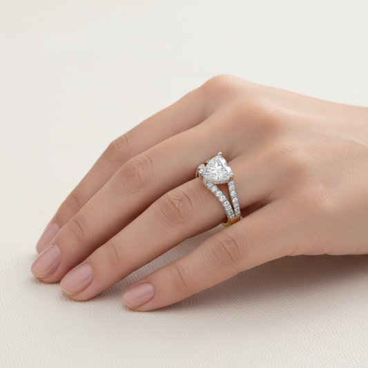 Two-tone gold heart-shaped diamond engagement ring with triple-row pavé split shank on model