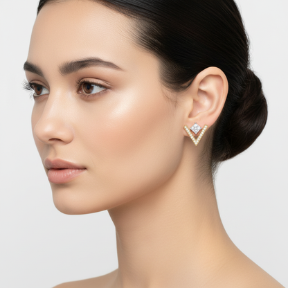 Two-tone gold princess-cut diamond stud earrings with V-shaped pavé jackets on model