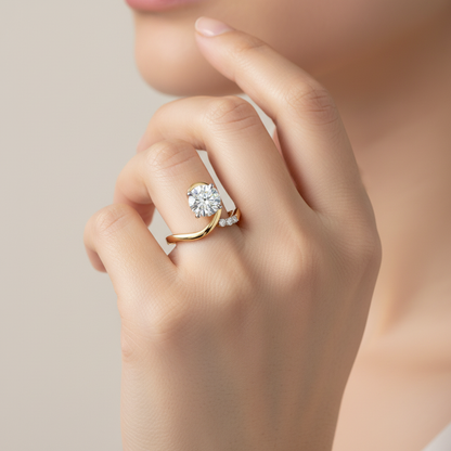 Two-tone gold solitaire engagement ring with curved wave band and diamond accents on model