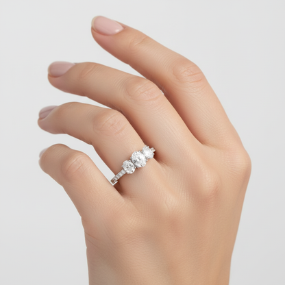 Two-tone three-stone oval diamond engagement ring on model