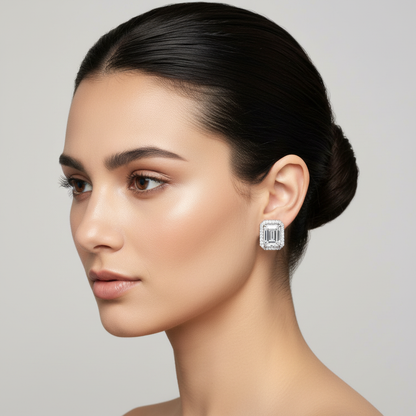 White gold emerald-cut diamond halo stud earrings on model