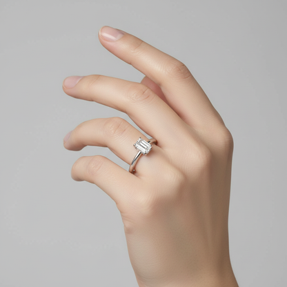 White gold emerald-cut diamond solitaire engagement ring on model