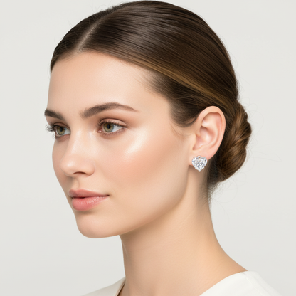 White gold heart-shaped diamond stud earrings on model