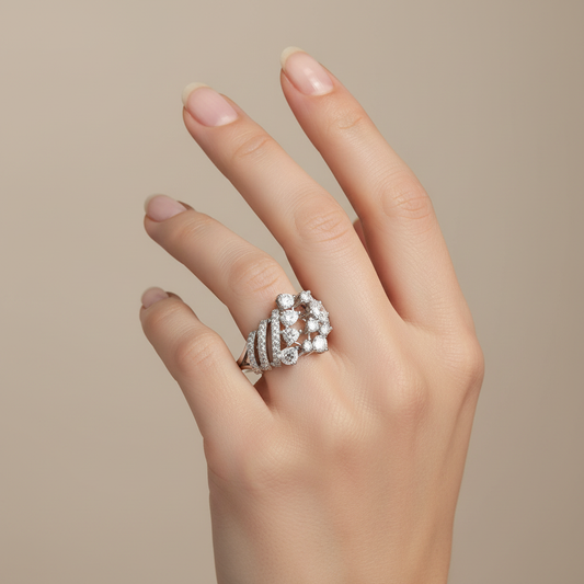 White gold mixed-cut diamond cluster ring with diagonal pavé bands on model