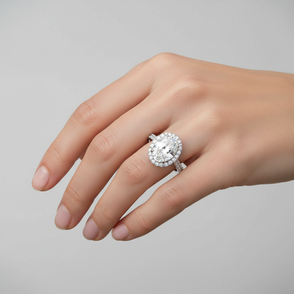 White gold oval diamond halo engagement ring with pavé band on model