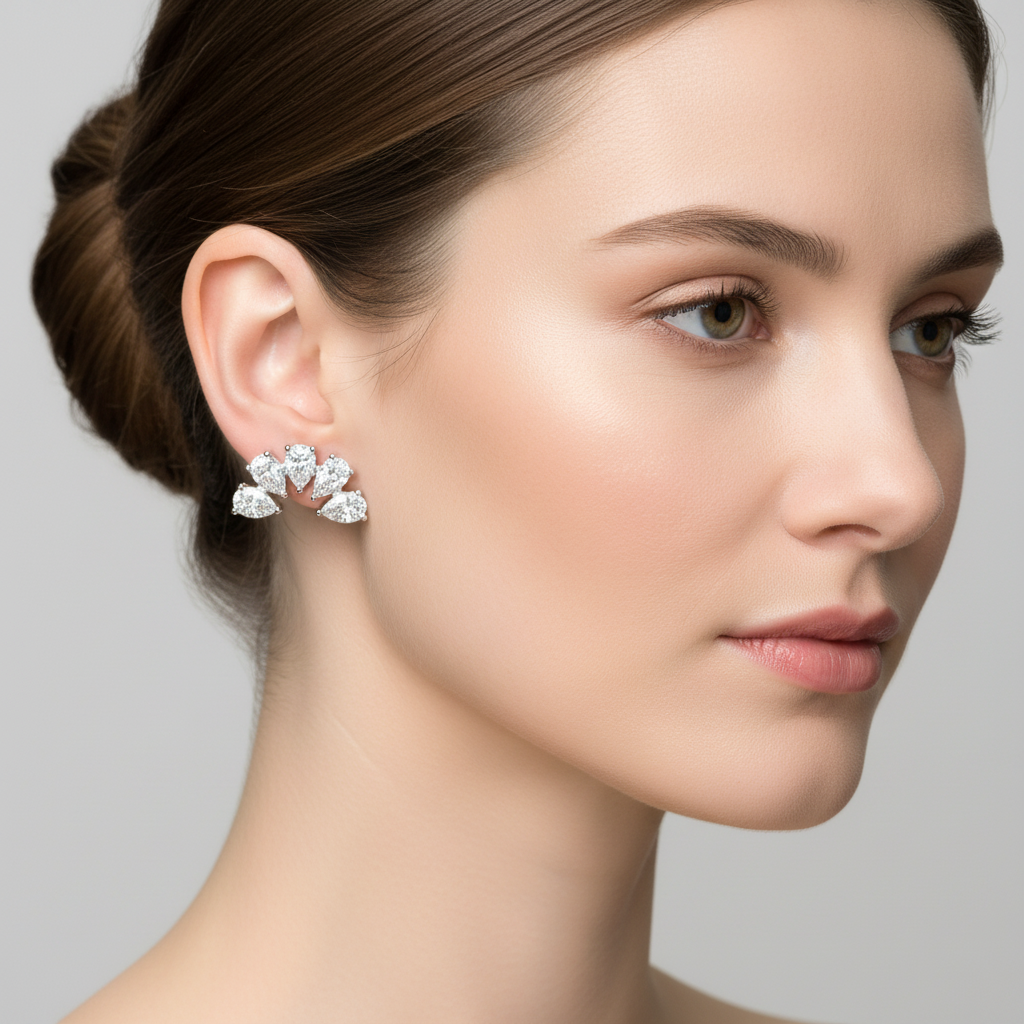 White gold pear-shaped and round diamond floral cluster ear climber earrings on model