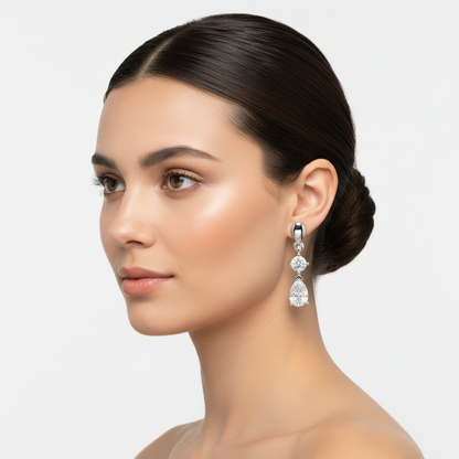 White gold round and pear-shaped diamond drop earrings on model