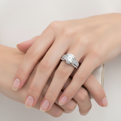 White gold round brilliant diamond engagement ring with hidden halo and triple-row split shank pavé band on model