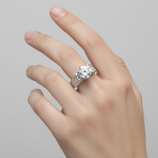White gold round brilliant diamond engagement ring with triple-row channel-set pavé band on model