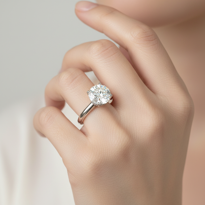 White gold round brilliant diamond solitaire engagement ring on model