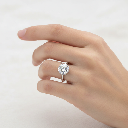 White gold round brilliant diamond solitaire engagement ring with hidden halo on model