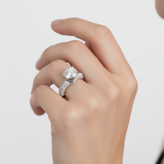 White gold round brilliant diamond solitaire engagement ring with triple-row pavé band on model